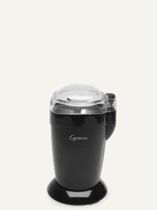 Front facing view of blade grinder with black base and clear lid.